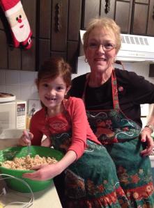 Grandma Karen and Casey wearing THOSE Christmas aprons while making holiday rice krispy treats!